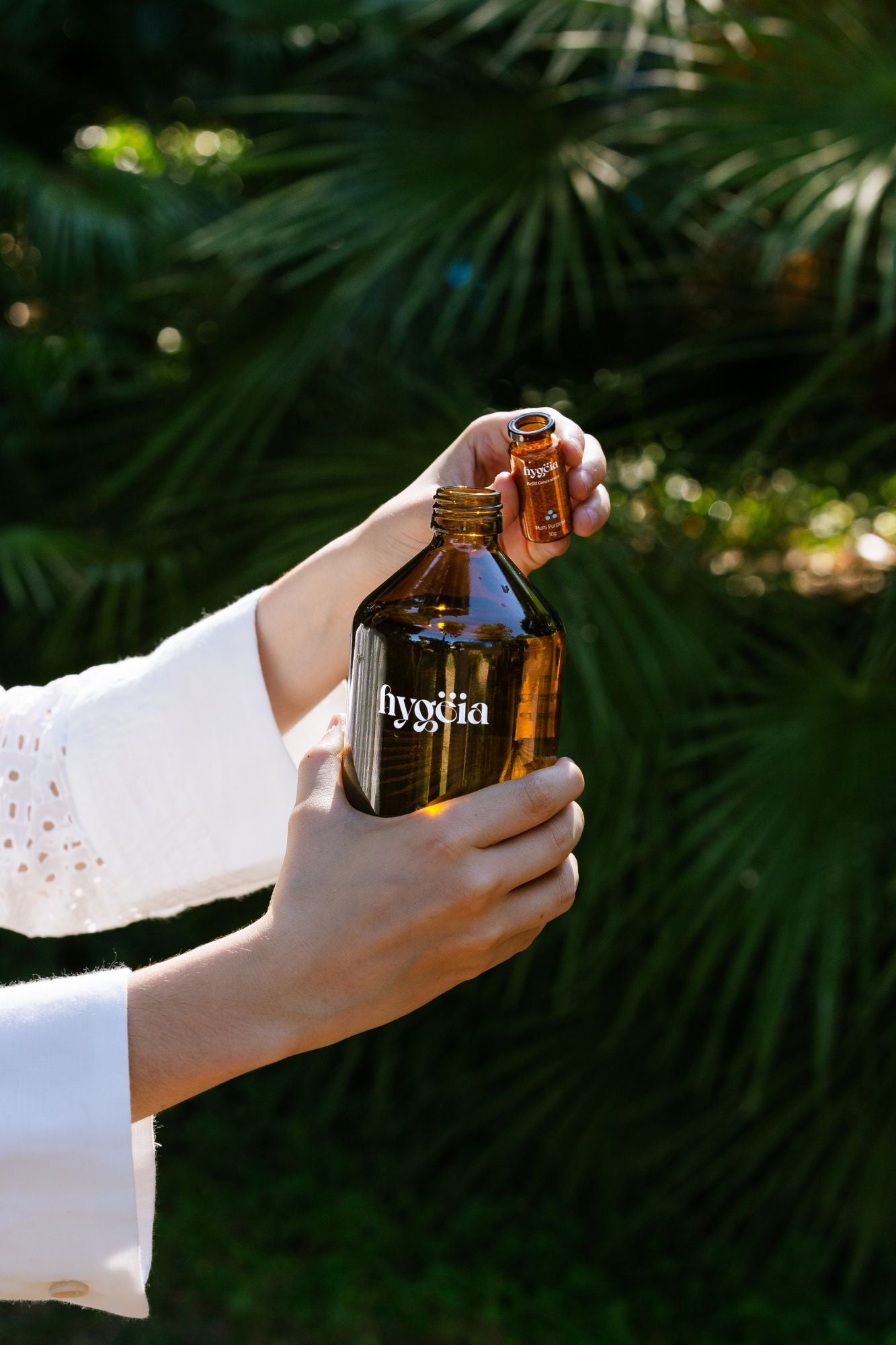 girl adding cleaning natural cleaning powder to refillable bottle